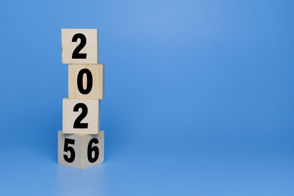 flip wooden blocks with year 2025 to 2026 isolated on blue background