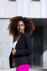 Black female turning around while standing outside of building