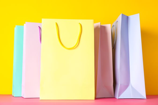 Color paper bags on multicolor background, space for text
