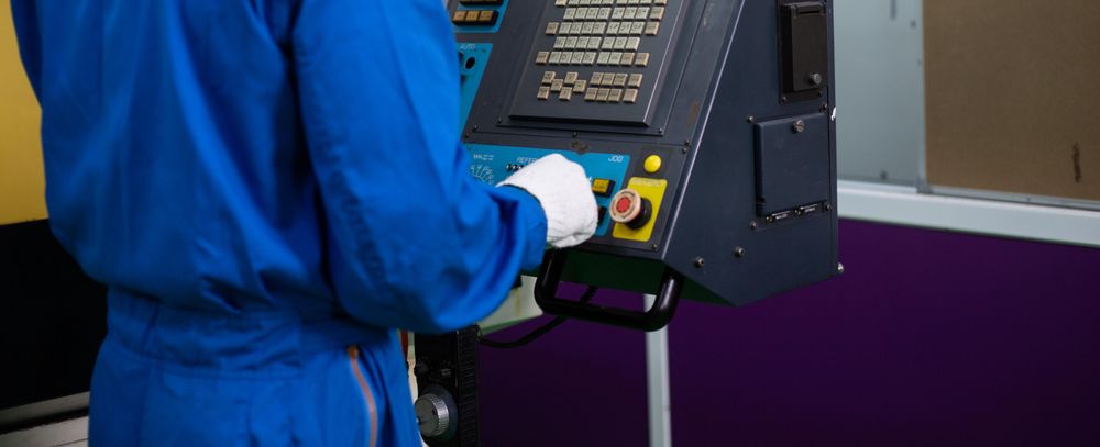 Banner of body of male operating machine in factory