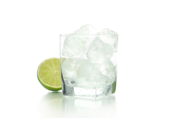 Rocks glass full of ice with a lime half