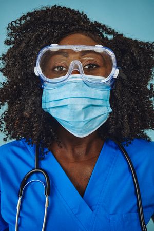 Close up of Black female medical professional wearing a face mask and protective eyewear