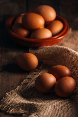 Chicken eggs on napkin on wooden table