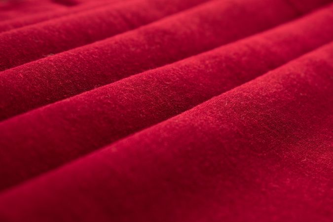 Close up Red folded Fabric Background Texture.