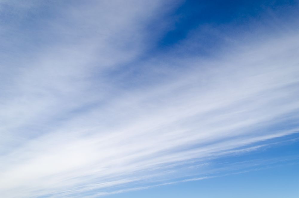 Diagonal cloudy lines in a perfect blue sky
