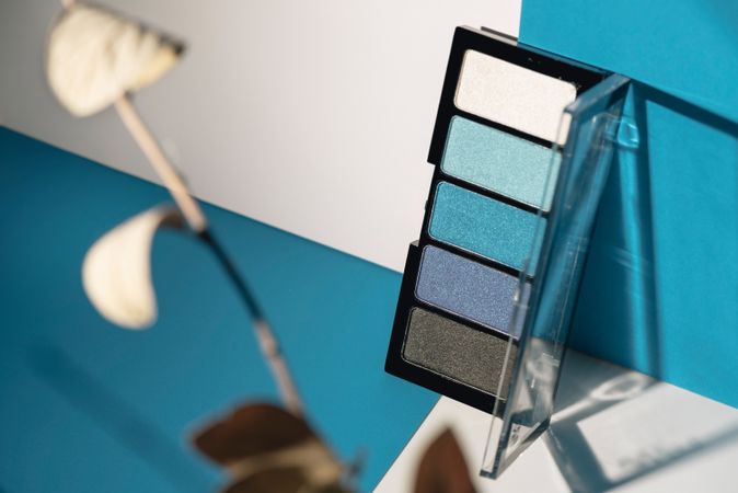 soft blue eyeshadow palette on geometric background.