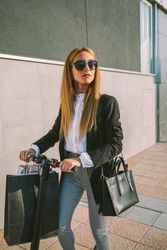 Woman with shopping bags on electric scooter