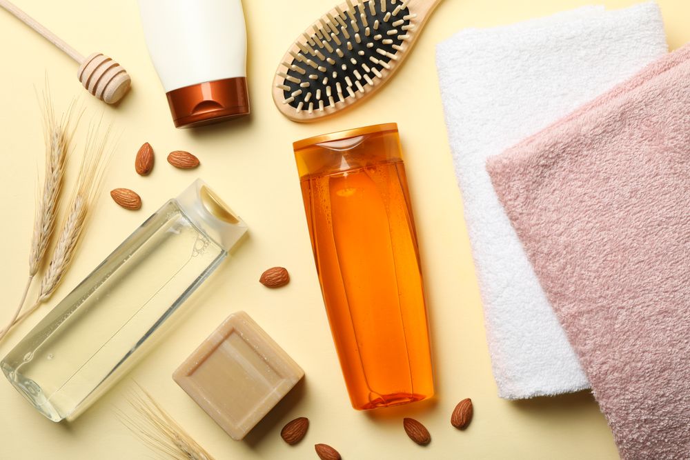 Composition of personal hygiene with bottles of cosmetics on beige background