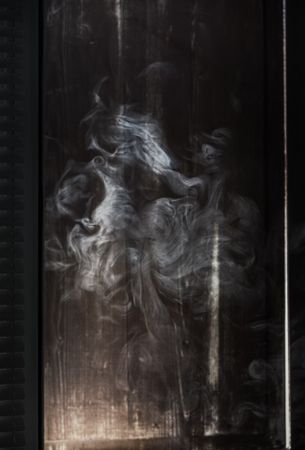 Smoke lit up in a dark room