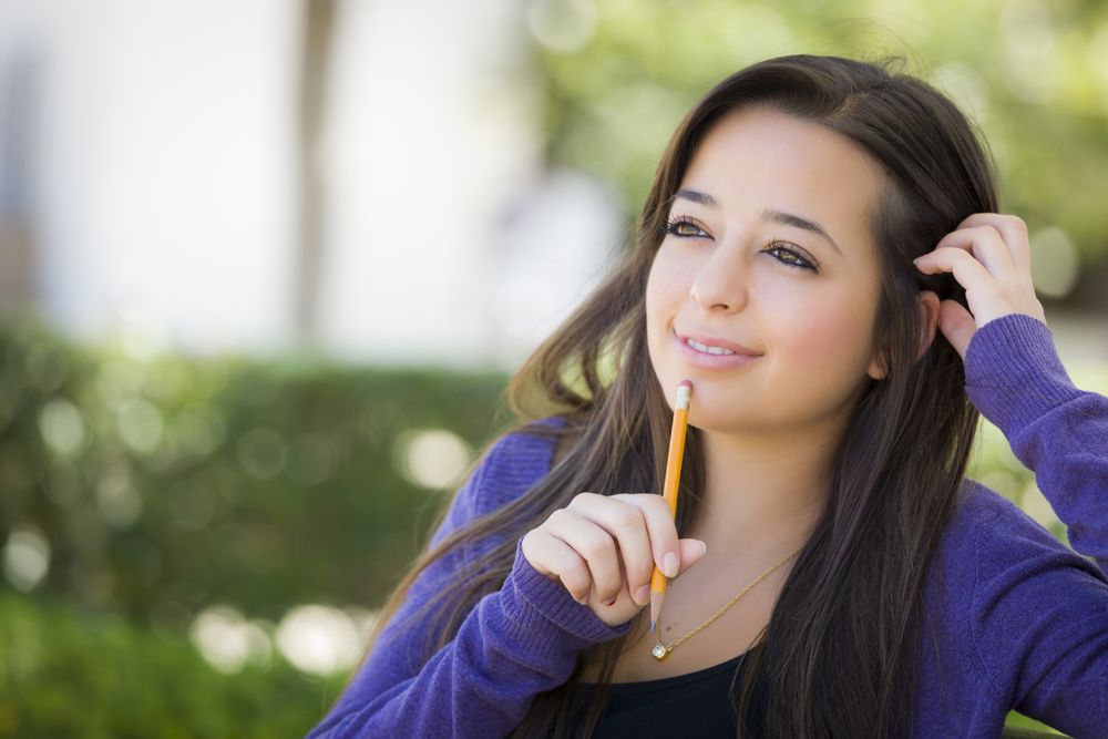 Female Student with Pencil on Campus
