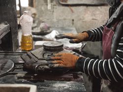 Unrecognizable man working with metal mold