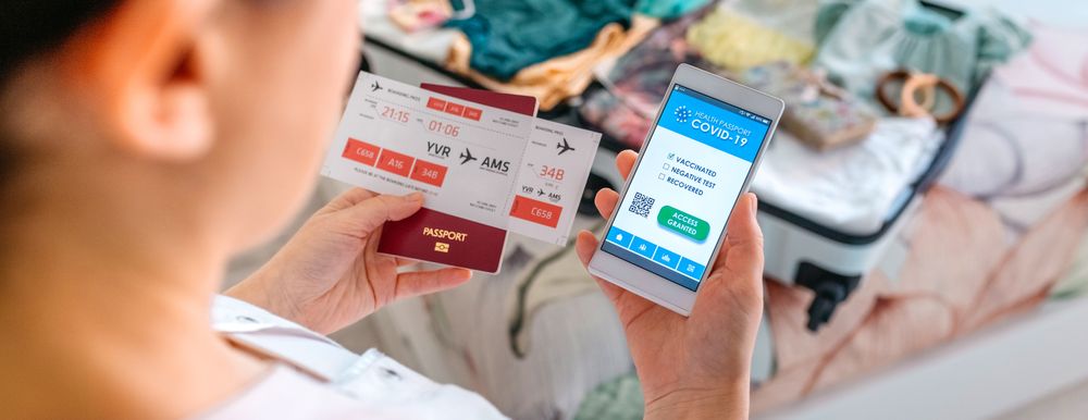 Woman preparing the suitcase and looking covid health passport o