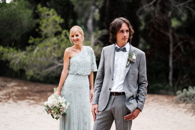 Happy married couple in wedding clothing at forest