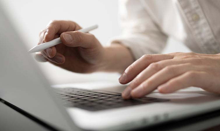 Man Using Stylus On Laptop