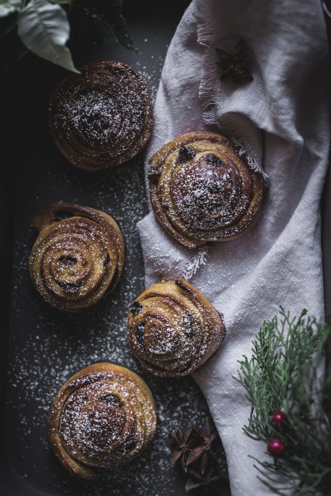 Herbs and napkin near cinnamon rolls