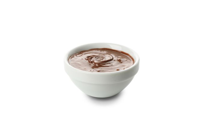 Bowl with melted chocolate isolated on blank background