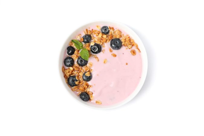 Yogurt with granola, blueberry and mint isolated on blank background