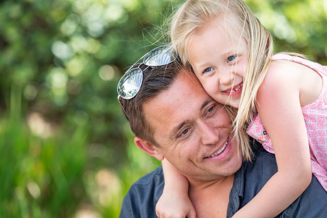 White Father and Daughter Having Fun At The Park