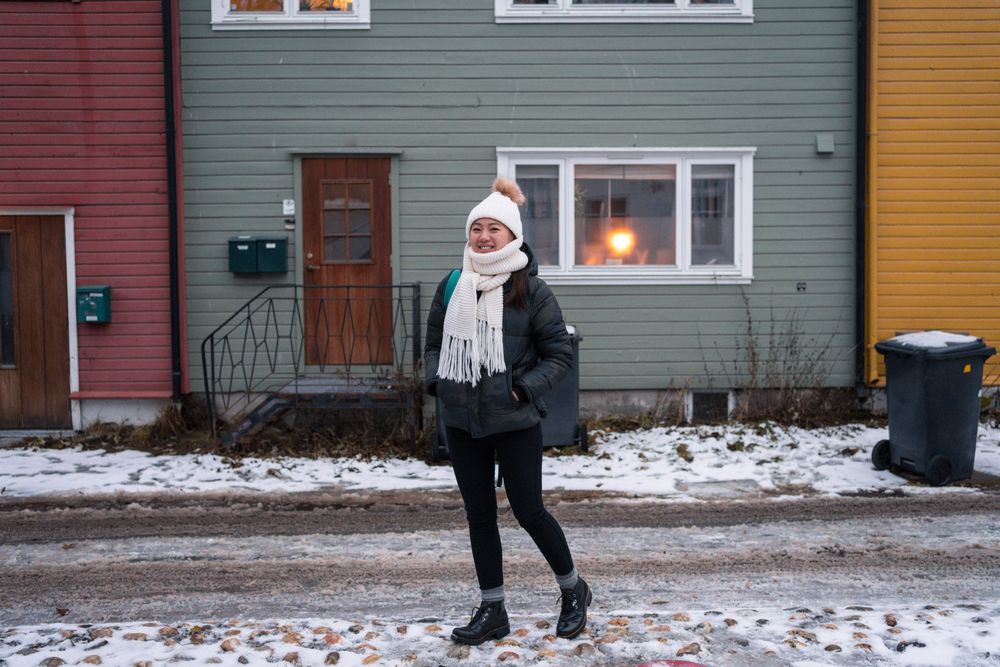 Cheerful female against northern house