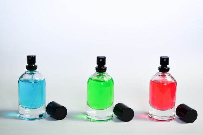 Three colorful perfume bottles