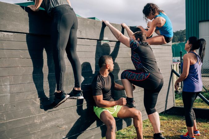 Participants in obstacle course climbing wall