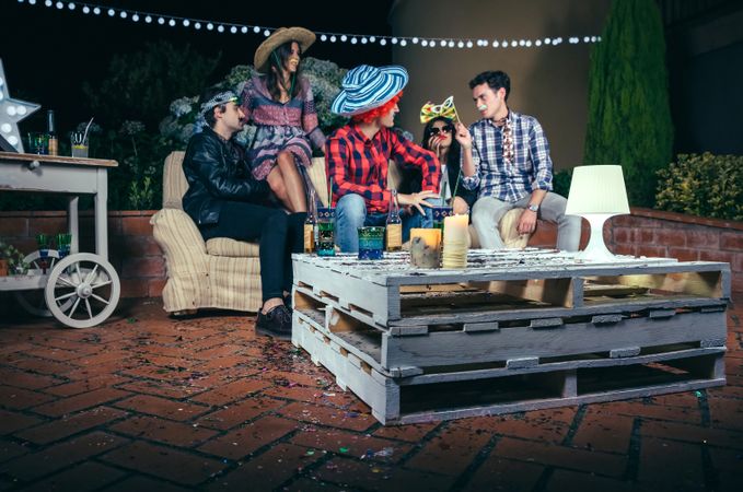 Pallet table with beverages and confetti at party