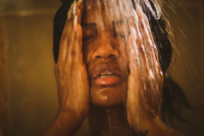 Cheerful female taking shower