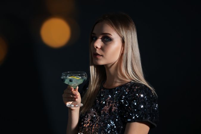 Concept of Halloween, young woman on dark background