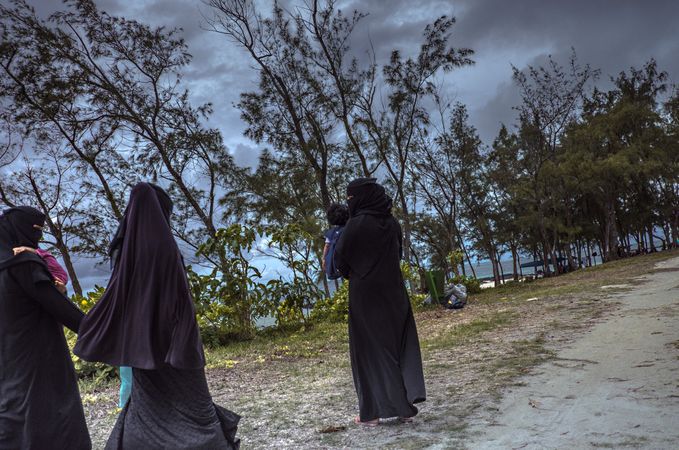 Muslim women walking to the beach