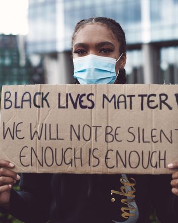 London, England, United Kingdom - June 6th, 2020: Woman in face mask with Black Lives Matter sign