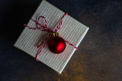 Top view of single Christmas gift with red bauble