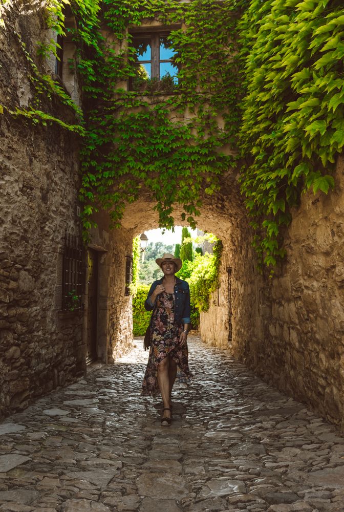 Woman walking in a narrow path in a village