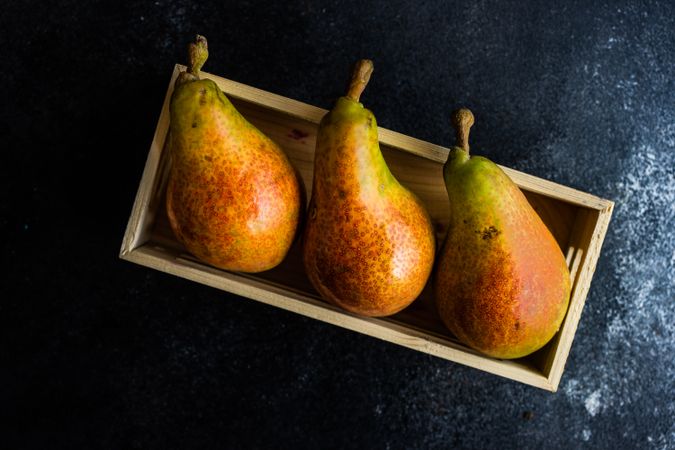 Three pears in wooden box