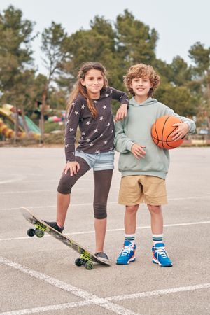 Smiling teenagers standing together in street