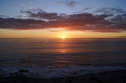 sandy and rocky beach and the ocean in sunset lights in canary island