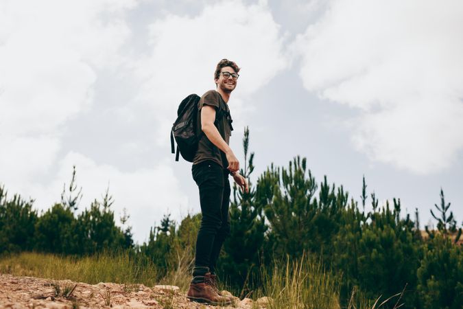 Young happy man hiking on a clear day