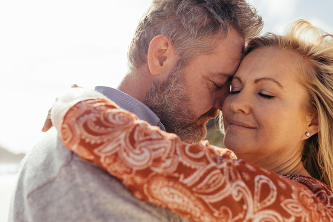 Affectionate mature couple embracing outdoors on beach