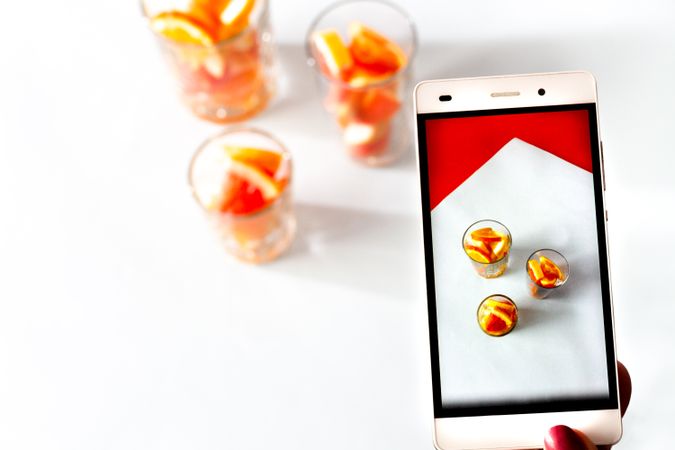 Photo of sliced citrus fruits on mobile phone