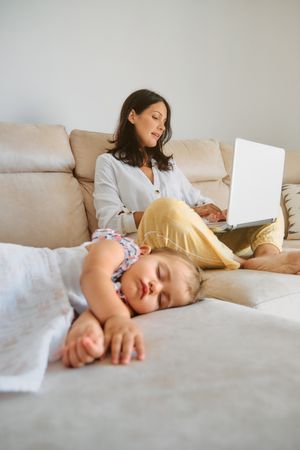 Woman working near sleeping baby at home