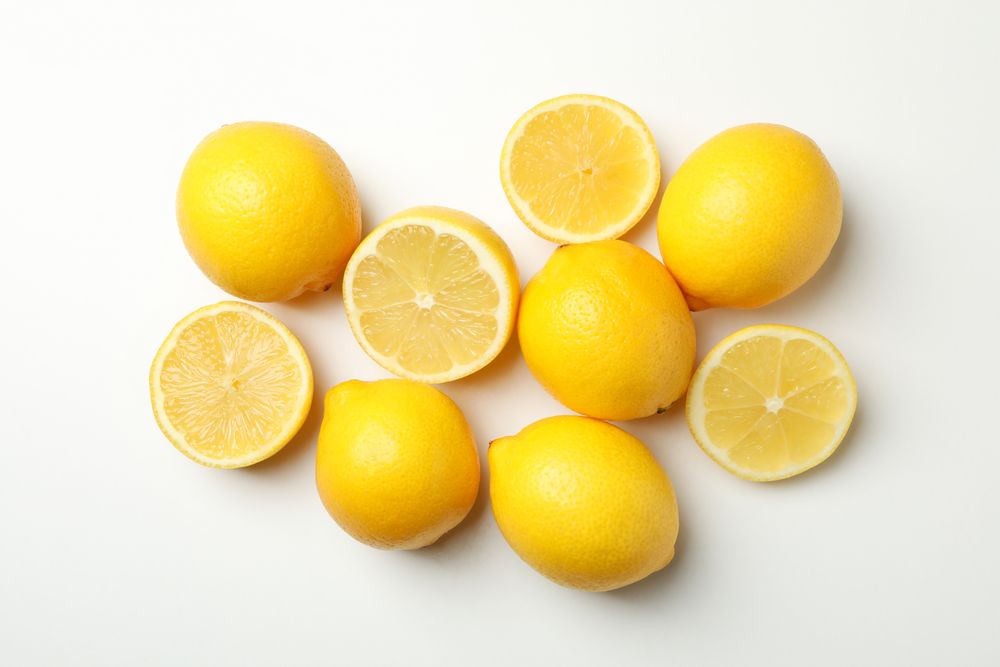 Fresh lemons on light background, top view. Ripe fruit