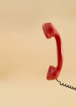 Ear piece of red vintage phone, vertical