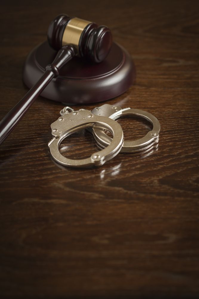 Gavel and Pair of Handcuffs on Table