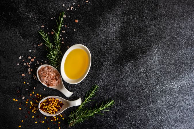 Spice cooking concept with pink salt, rosemary and oil