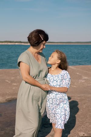 Grandmother and granddaughter by the sea