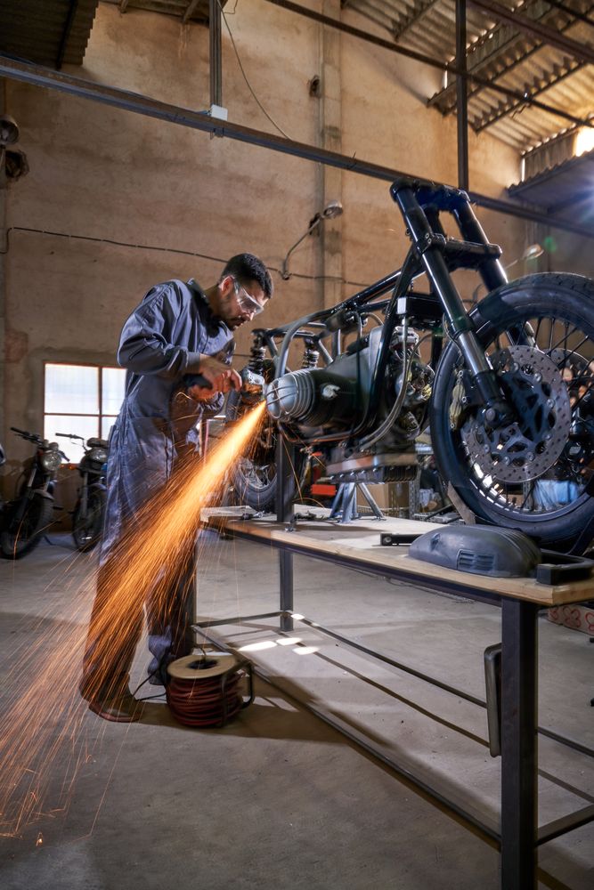 Adult male mechanic working in professional workshop