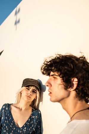Couple leaning on wall contemplating