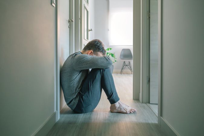 Man crying sitting on the floor