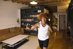 Young man warming up at home.