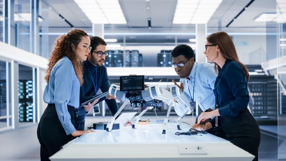 Portrait of a Young Team of Multicultural Engineers Use Computers