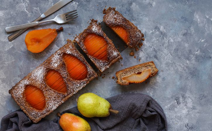 Pear cake and fruits on table